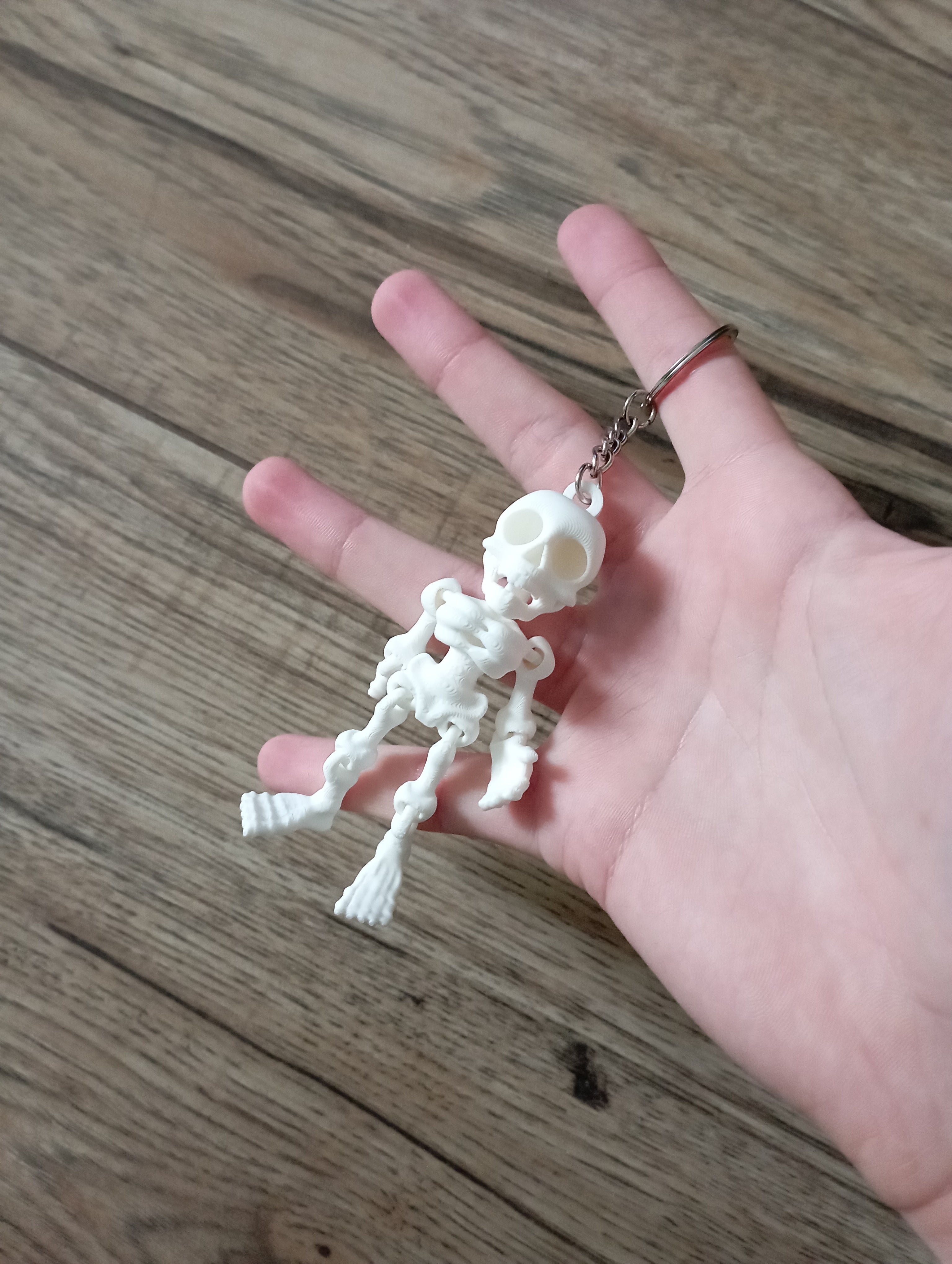 Brelok ruchomy kościo trupek w kolorze białym.